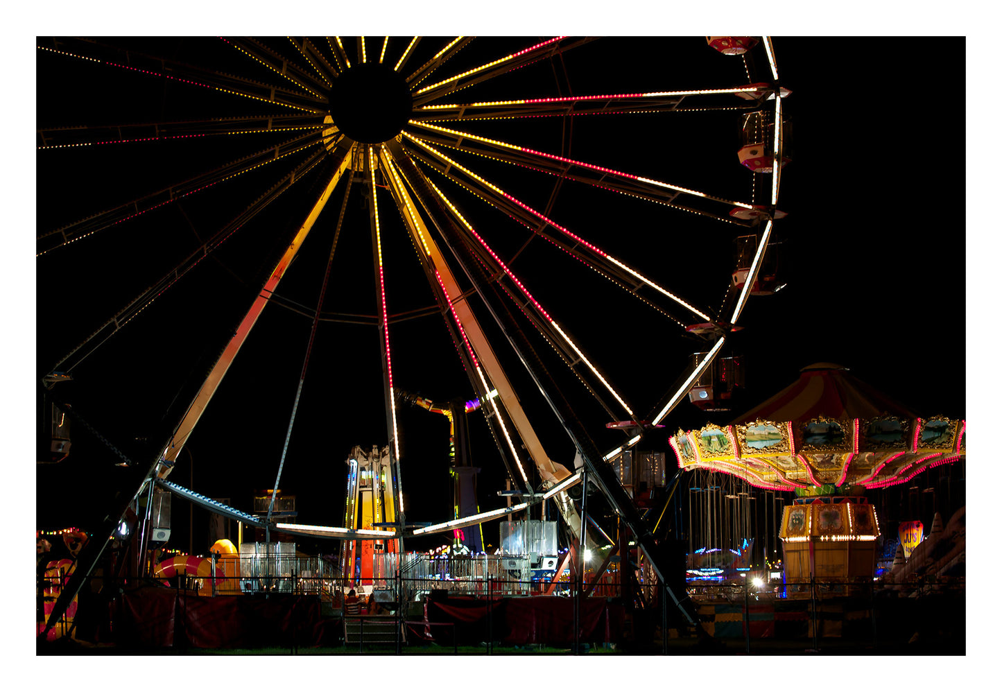 Fairground Carnival Lights 6900003v3 - 104x74cm, Ferris wheel glowing against twilight sky with carnival rides below, fine art limited edition print by Raymond Mather, ART1.