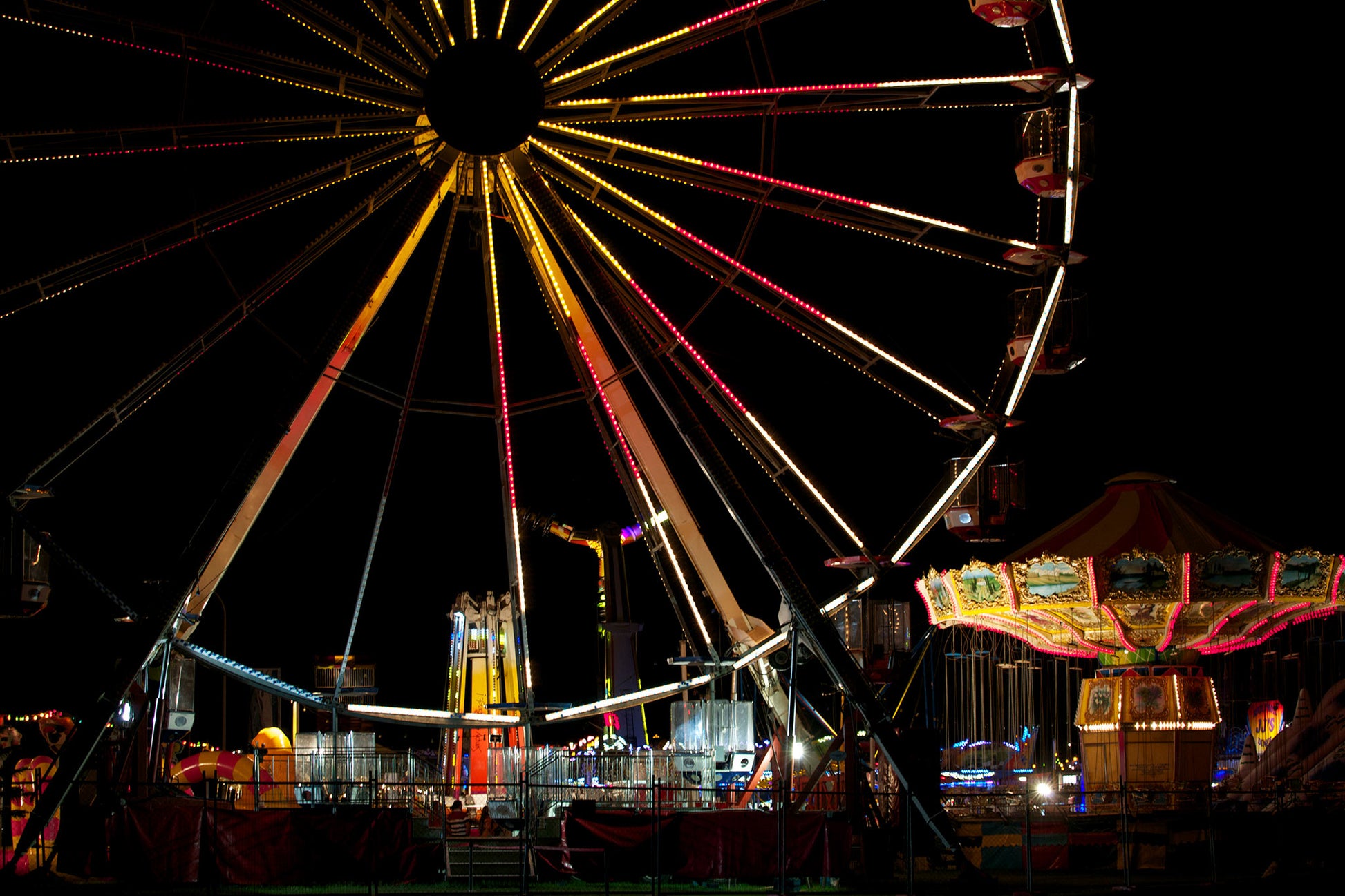 Fairground Carnival Lights 6900003v3 - 90x60cm, Ferris wheel glowing against twilight sky with carnival rides below, fine art limited edition print by Raymond Mather, ART1.