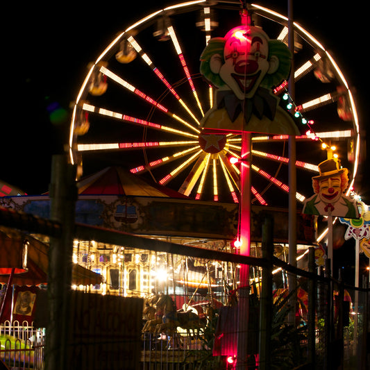 Fairground Carnival Lights 6900083 - Close Detail View, night carnival view with Ferris wheel, glowing rides, and striking clown figure, fine art limited edition print by Raymond Mather, ART1.