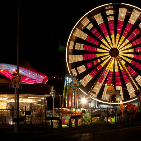 Fairground Carnival Lights 6900102 - Close Detail View, illuminated Ferris wheel and carnival rides at night with vivid red and yellow lights, fine art limited edition print by Raymond Mather, ART1.