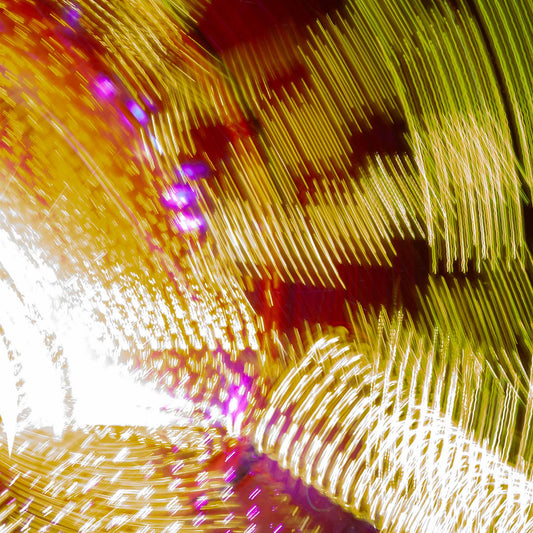 Fairground Carnival Lights 6900131 - Close Detail View, an abstract long exposure of carnival lights in motion, forming sweeping ribbons of gold, red, white, and purple across the frame. Captured by Raymond Mather, this fine art photograph transforms fairground energy into a dynamic light composition.
