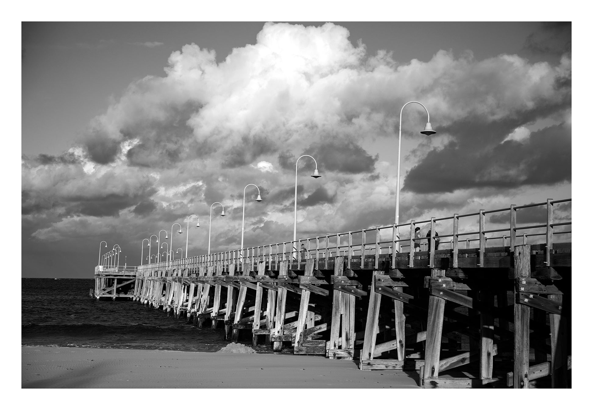 Monochrome Mix - Jetty - Coffs Harbour - 186500v1 - 104x74cm, A black and white photograph of the Coffs Harbour jetty under a sky of dramatic clouds, with strong structural contrast and sweeping perspective. Limited edition fine art print.