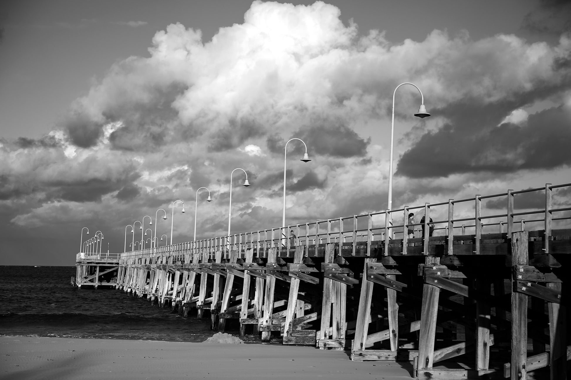 Monochrome Mix - Jetty - Coffs Harbour - 186500v1 - 90x60cm, A black and white photograph of the Coffs Harbour jetty under a sky of dramatic clouds, with strong structural contrast and sweeping perspective. Limited edition fine art print.