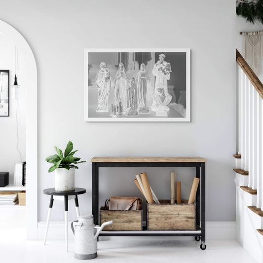 Monochrome Mix - Icons on the Mantel - 183072 - Room View, A monochrome image of religious figurines grouped on a mantel, including various Madonnas, saints, and a bust of Christ, evoking a serene and personal shrine.