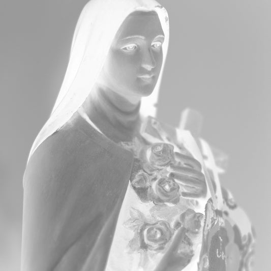 Monochrome Mix - Icons on the Mantel - 183073 - Close Detail View, A soft black and white image of Saint Thérèse of Lisieux holding roses and a cross, exuding peaceful grace and spiritual tenderness.