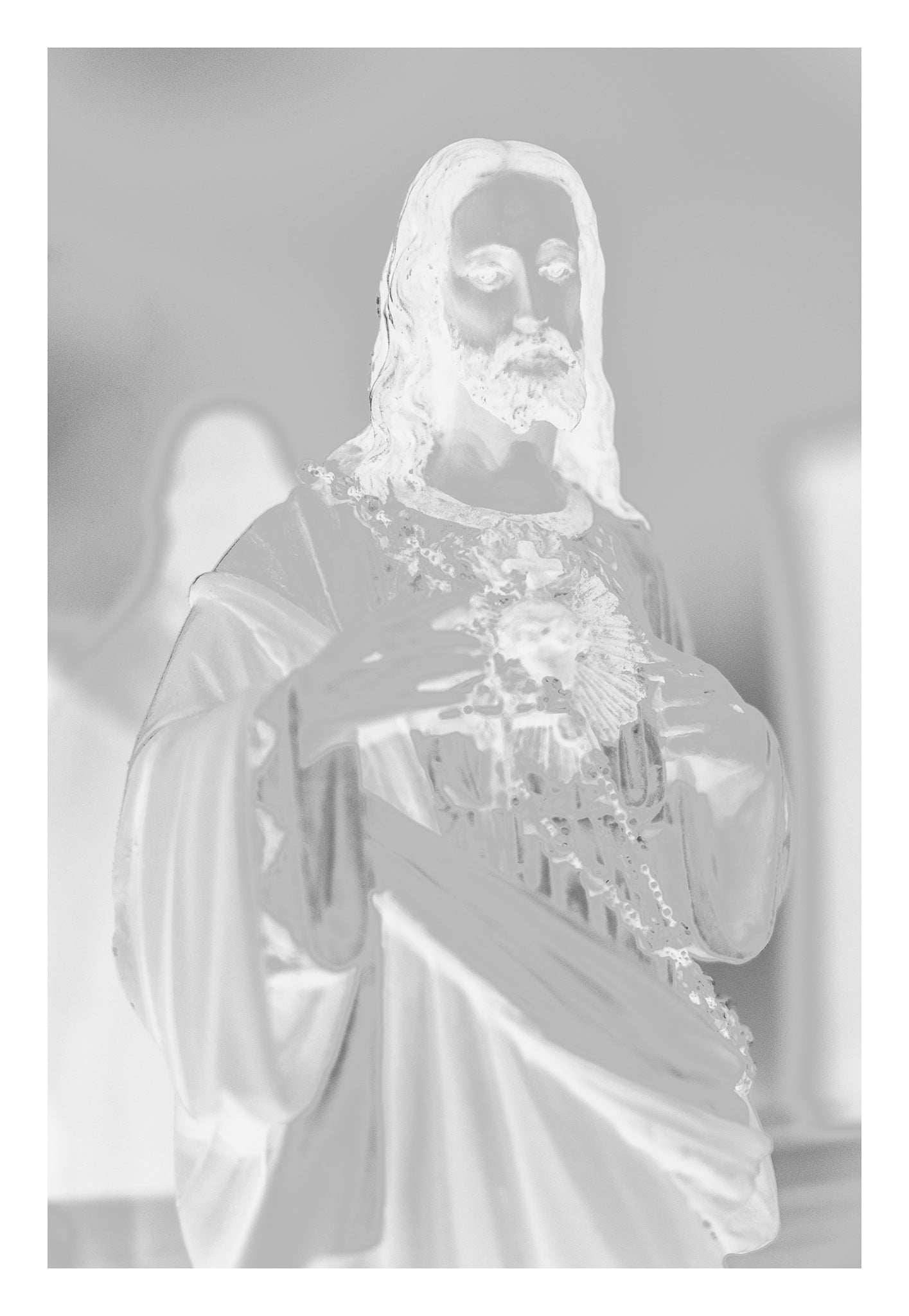 Monochrome Mix - Icons on the Mantel - 183081 - 74x104cm, Soft-focus black and white image of a Sacred Heart of Jesus statue, with subtle ethereal lighting evoking spiritual presence and quiet reverence.