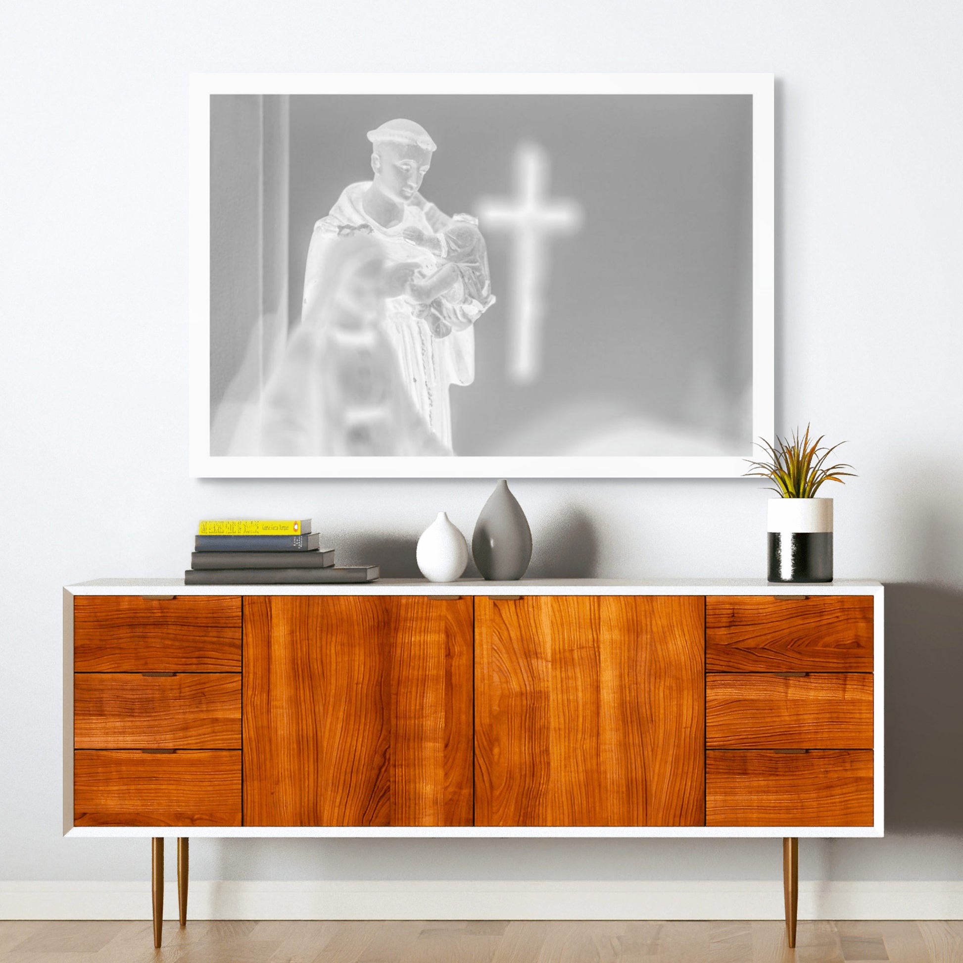 Monochrome Mix - Icons on the Mantel - 183102 - Room View, Black and white image of a Saint Anthony statue holding baby Jesus, with a glowing cross in the blurred background, evoking spiritual reflection and reverent stillness.
