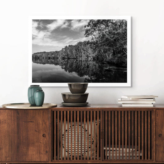 Monochrome Mix - River Reflection - 160689v2 - Room View, A black and white landscape, Bongil Bongil National Park of a still river bordered by tall trees, their reflections mirrored clearly in the water. Serene, symmetrical nature study. Limited edition fine art print.