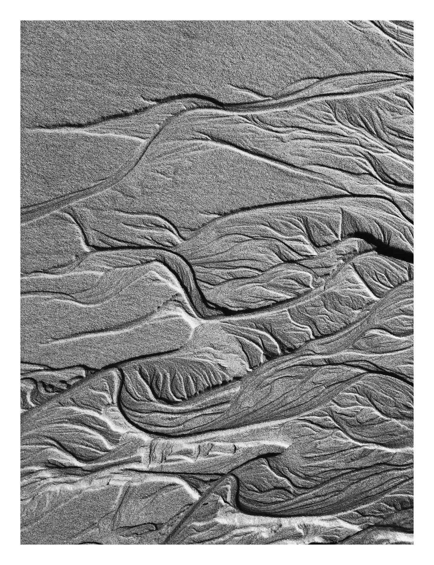 Monochrome Mix - Scotts Head - Beach Sand Tidal Forms - 19E4544 - 81.5x104cm, Vertical black and white photograph showcasing finely textured tidal sand formations with flowing, organic patterns on the beach at Scotts Head.