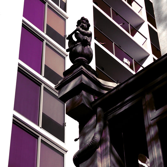 POPscape Sydney - Darlinghurst - Building Statue - 1906064v16 - Close Detail View, Stylised image of a cherub statue atop a heritage building, surrounded by modern high-rise architecture in Darlinghurst. Muted purples and dark tones create dramatic Pop Art contrast.