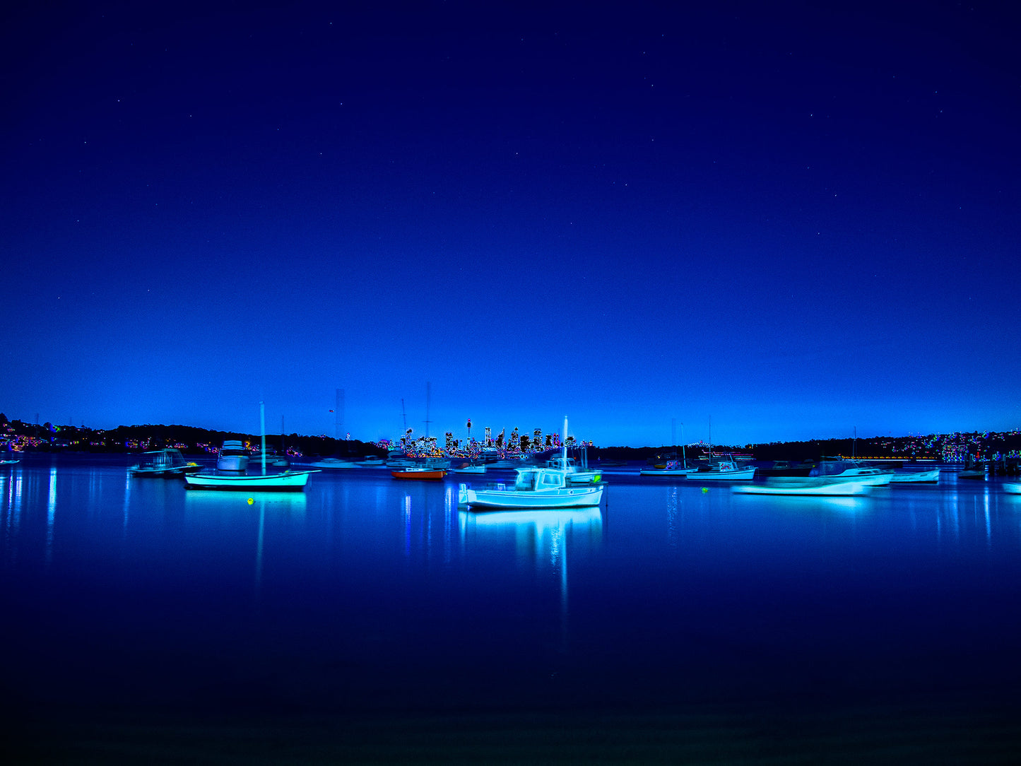 POPscape Sydney - Watsons Bay - Boats Night - 100970v2b3 - 90x67.5cm, Stylised night photograph of illuminated boats floating in Watsons Bay, Sydney. Deep blue tones and glowing highlights reflect on calm water under a star-speckled sky. Pop Art-style treatment with dreamlike vibrancy.