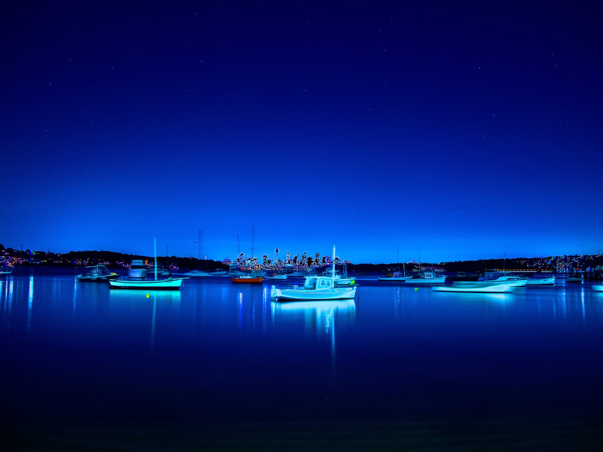 POPscape Sydney - Watsons Bay - Boats Night - 100970v2b3 - 90x67.5cm, Stylised night photograph of illuminated boats floating in Watsons Bay, Sydney. Deep blue tones and glowing highlights reflect on calm water under a star-speckled sky. Pop Art-style treatment with dreamlike vibrancy.