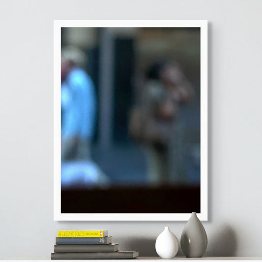 Urban Commute - Series No.1: 0978v1 - Room View, a soft focus photograph of two city commuters: one in a blue shirt walking left, and another mid call, set against a shadowed urban backdrop. A contemplative image of separation and movement. Limited edition fine art print by Raymond Mather.