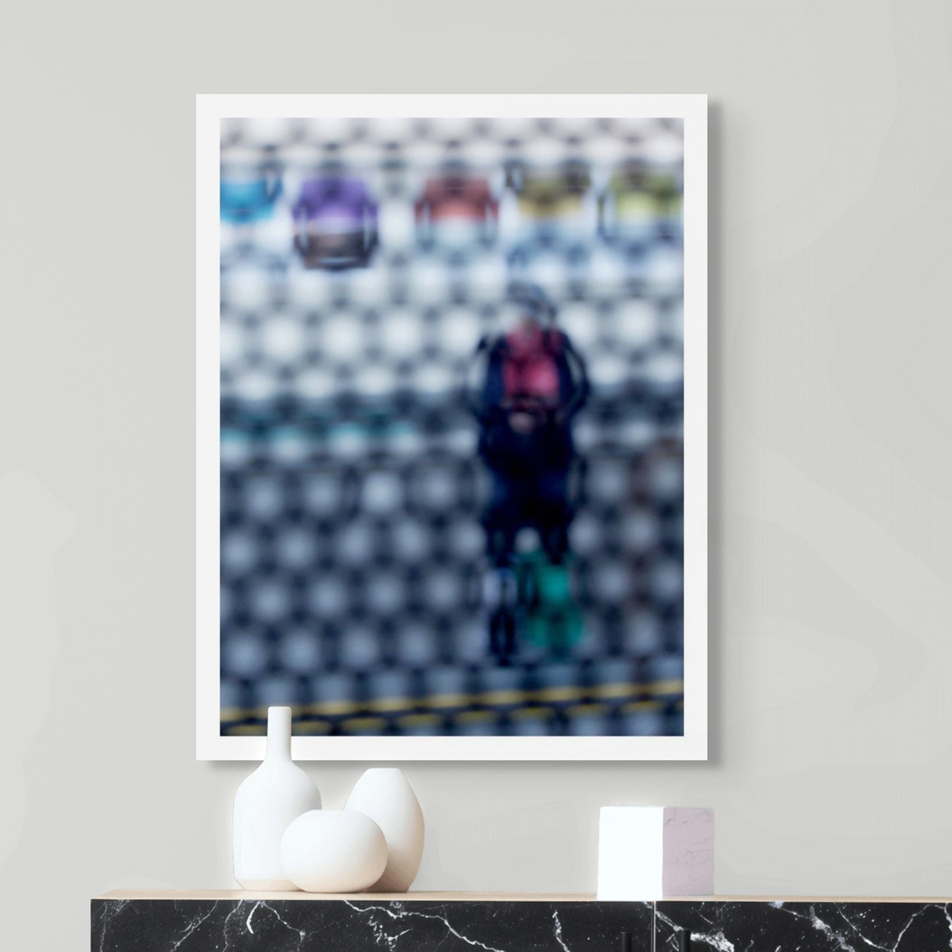 Urban Commute - Series No.2: 9153 - Room View, fine art photograph by Raymond Mather showing a blurred figure in red and navy with a backpack and helmet, standing before a row of colourful train seats. Seen through a circular grid, the image evokes themes of pause, movement, and visual abstraction.