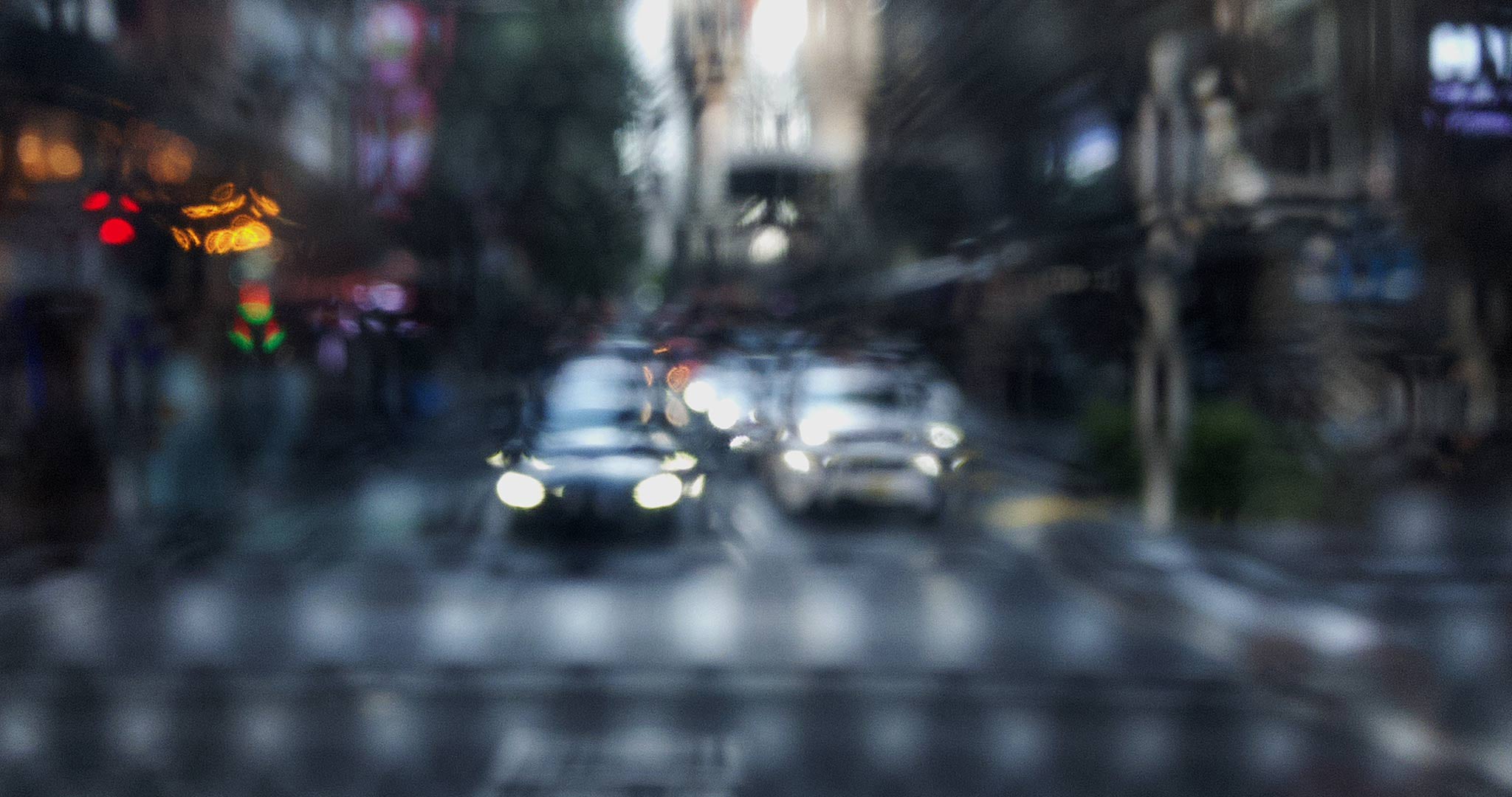 Urban Commute Series No.2 9201_1_v1a, limited edition fine art photographic artwork featuring blurred city traffic and headlights on a rain-soaked urban street at night, conveying motion and transience, by Raymond Mather, ART1 Fine Art Photography