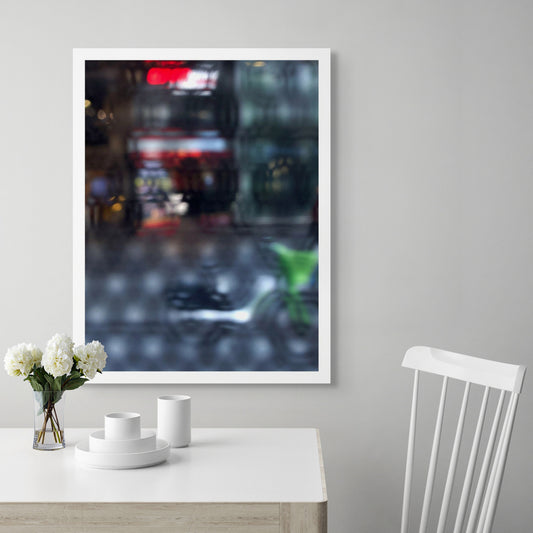 Urban Commute - Series No.2: 9206v1 - Room View, fine art photograph by Raymond Mather featuring a blurred green bike in the foreground, with a red neon-lit storefront behind a softly distorted surface. A moody and abstract urban scene evoking energy and reflection.