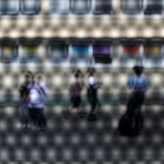 Urban Commute - Series No.2: 9557(1)v1a - Close Detail View, fine art photograph by Raymond Mather showing a group of pedestrians viewed through a circular patterned screen, with a colourful row of panels or bins behind them. The scene is abstracted into a rhythmic visual composition.