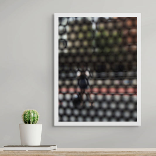 Urban Commute - Series No.2: 9568 - Room View, fine art photograph by Raymond Mather featuring a blurred, solitary pedestrian viewed through a patterned screen. Muted tones and soft outlines evoke warmth, introspection, and urban stillness.