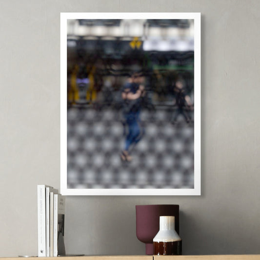 Urban Commute - Series No.2: 9609 - Room View, fine art photograph by Raymond Mather featuring a blurred morning commuter with a backpack, seen mid-stride through a patterned surface. Another figure passes in the background. A layered urban image of movement and solitude.