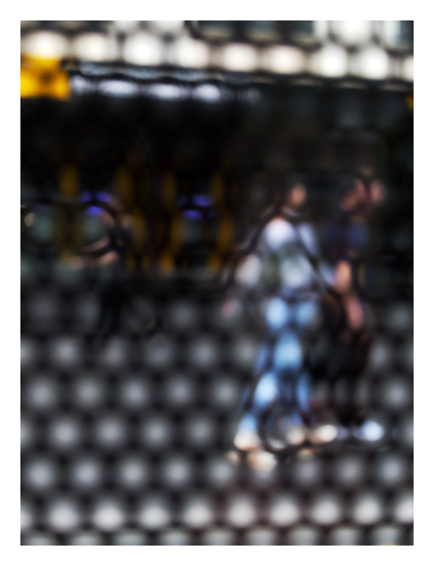 Urban Commute - Series No.2: 9611 - 81.5x104cm, abstract city street scene with two blurred figures walking side by side through a honeycomb patterned filter, with warm ambient light, soft shadows, and diffuse reflections suggesting early morning movement, limited edition fine art print by Raymond Mather, ART1