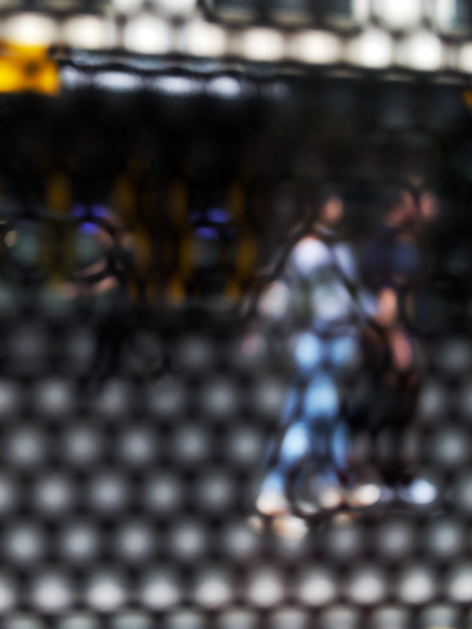 Urban Commute - Series No.2: 9611 - 67.5x90cm, abstract city street scene with two blurred figures walking side by side through a honeycomb patterned filter, with warm ambient light, soft shadows, and diffuse reflections suggesting early morning movement, limited edition fine art print by Raymond Mather, ART1.