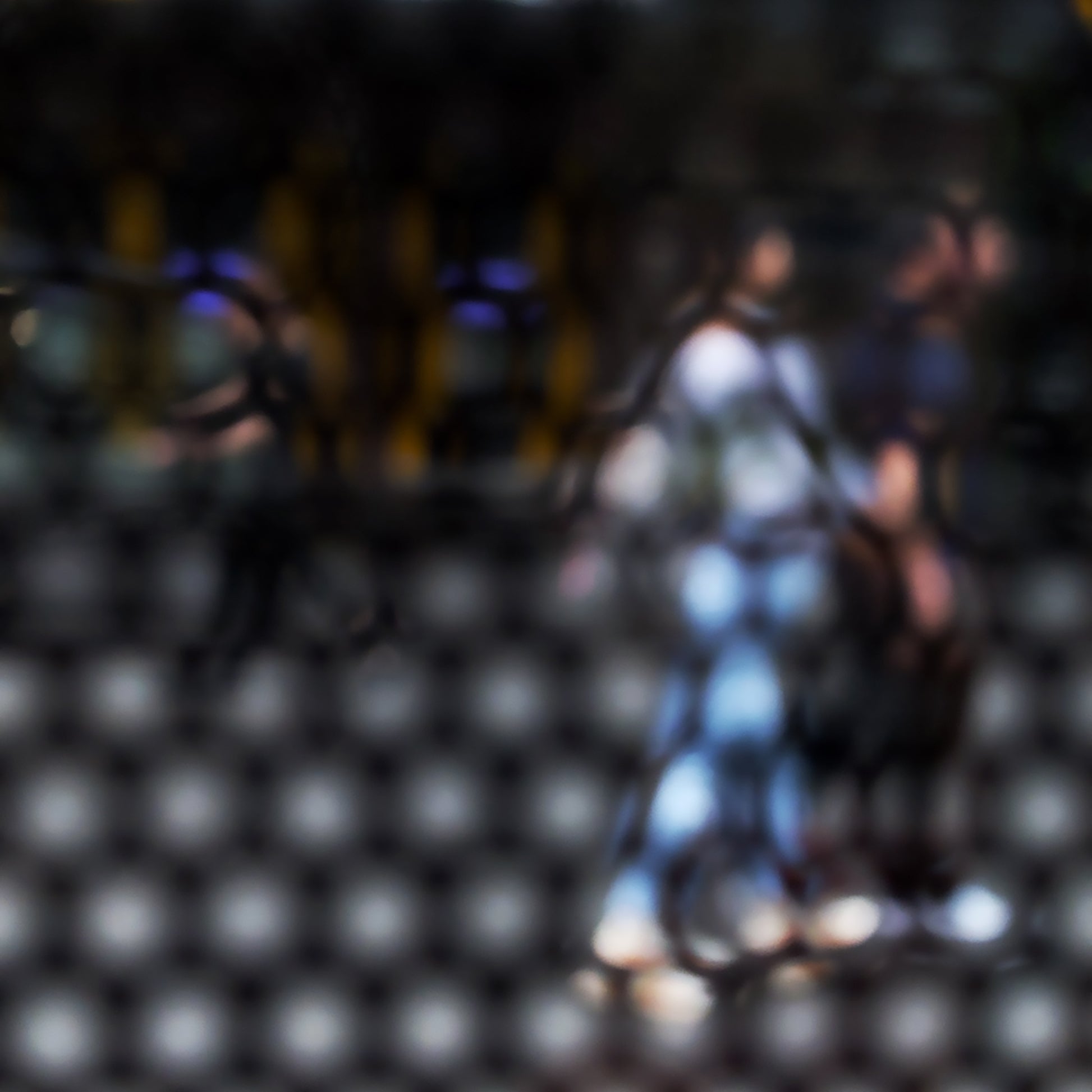 Urban Commute - Series No.2: 9611 - Close Detail View, abstract city street scene with two blurred figures walking side by side through a honeycomb patterned filter, with warm ambient light, soft shadows, and diffuse reflections suggesting early morning movement, limited edition fine art print by Raymond Mather, ART1.