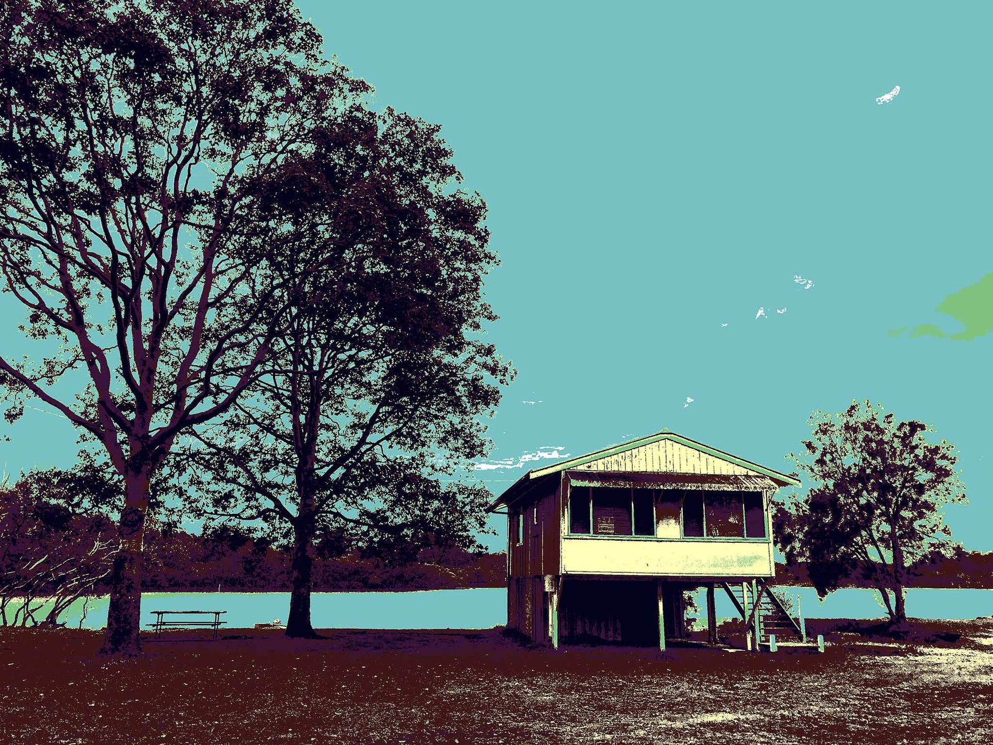 Vivid Country - Urunga River House - 6393v44 - 90x67.5cm, a raised riverfront house stands beside tall silhouetted trees in Urunga, rendered in muted Pop Art tones of teal, brown, and green. A tranquil riverscape with a picnic bench evokes a sense of stillness and simplicity.