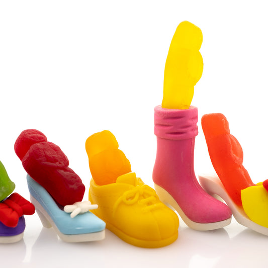 Walk a Mile in My Shoes 2805v1 - Close Detail View, fine art photograph by Raymond Mather featuring brightly coloured jelly baby figures placed playfully inside an eclectic mix of miniature shoes. A pop art composition that brings a humorous twist to empathy and individuality.